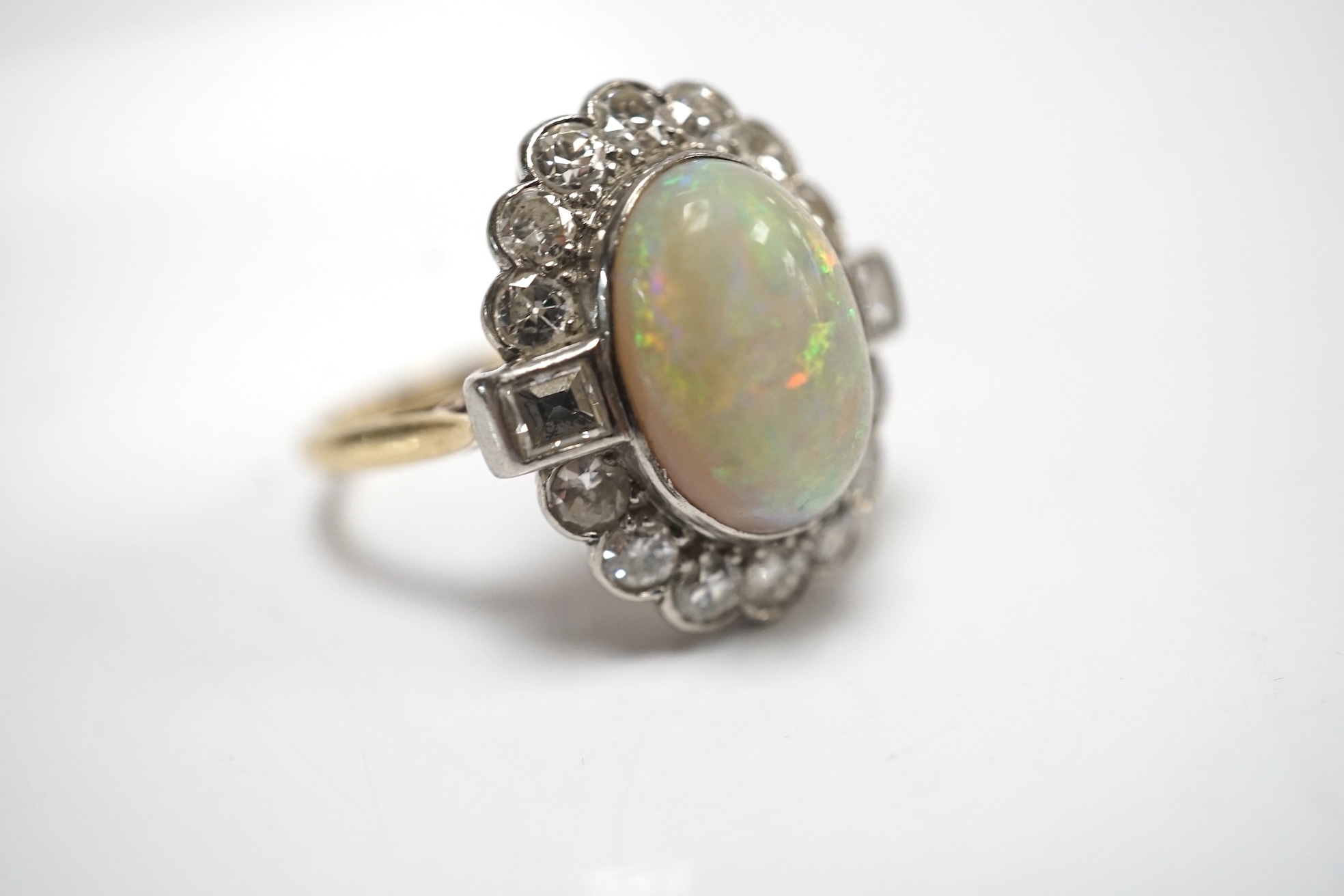 A mid 20th century 18ct, white opal, square and round cut diamond set oval cluster ring, size O, gross weight 3.3 grams. Condition - fair